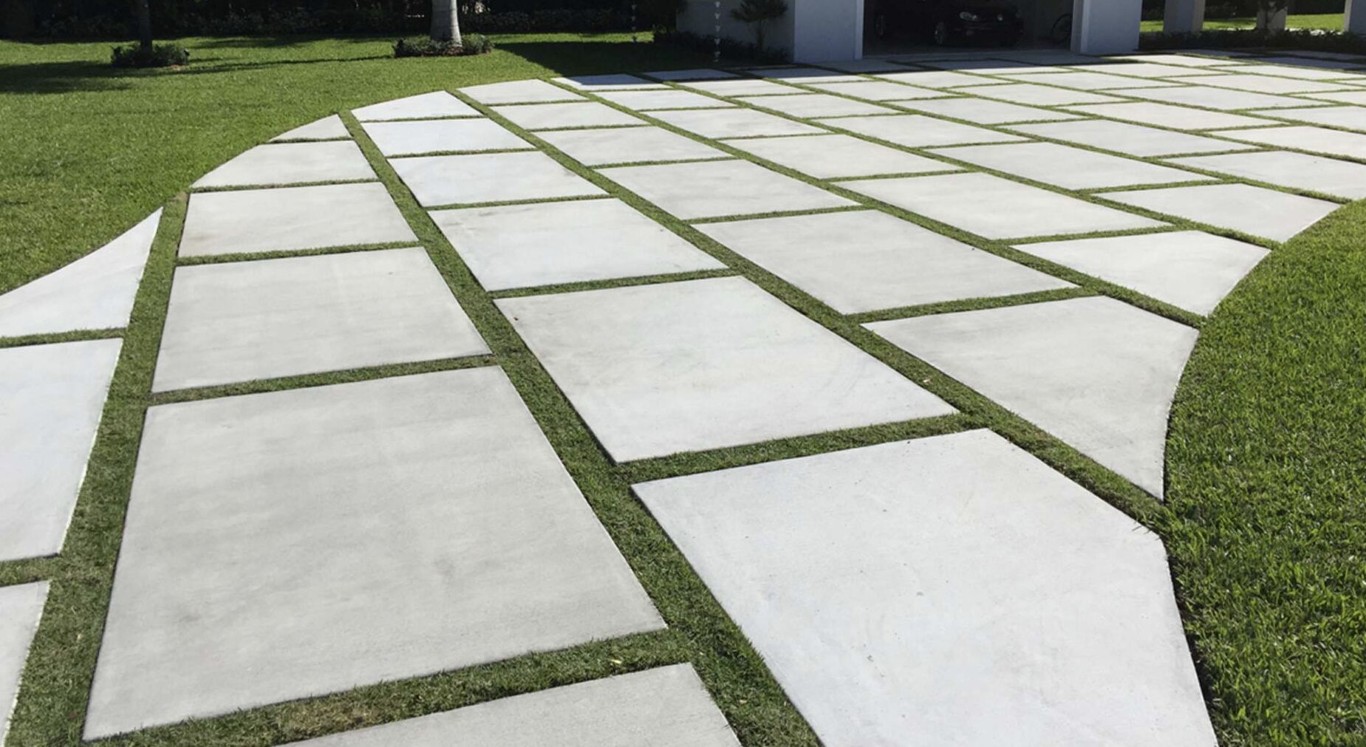 Modern concrete driveway with grass joints creating elegant geometric design